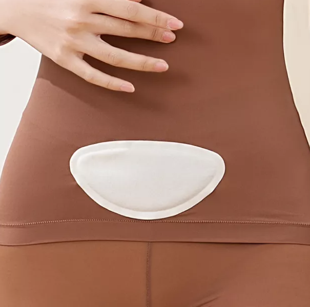 Image of a menstrual heat patch applied to the lower abdomen, providing targeted warmth for menstrual pain relief.