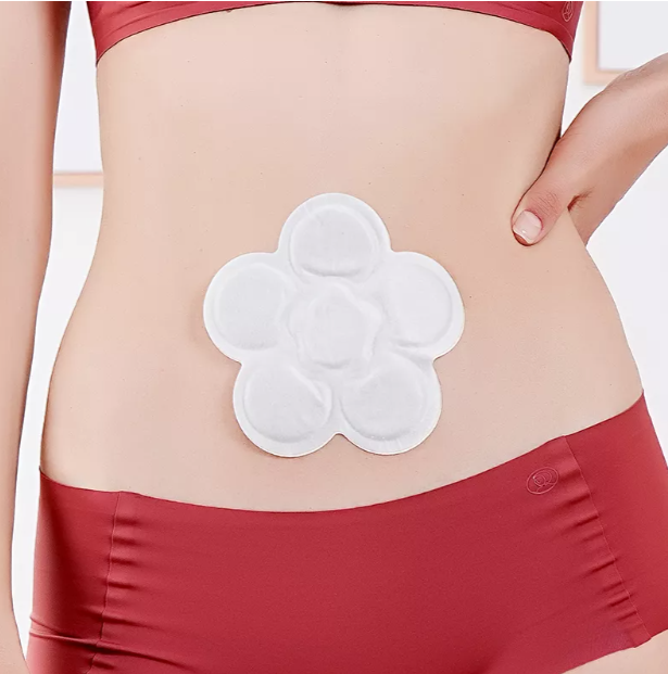 Image of a menstrual heat patch designed for soothing relief from menstrual cramps, placed on the lower abdomen for targeted warmth and comfort.